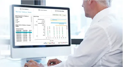 Man looking at monitor with medical graphs