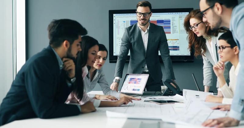 A group of business professionals in a meeting room