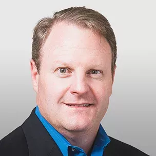 Kevin W. headshot image with a grey background