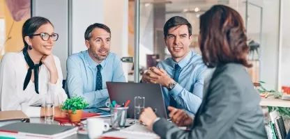Individuals in a conference room in a meeting