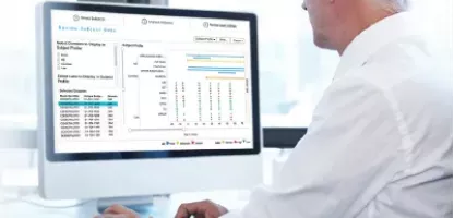 Man looking at monitor with medical graphs