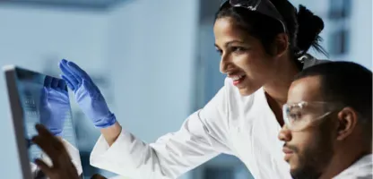 man and woman scientist looking at monitor